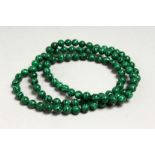 A MALACHITE STRING OF BEADS