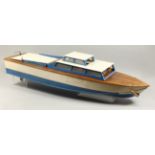 A LARGE MODEL CABIN CRUISER, cream and blue, with engine. 44ins long.