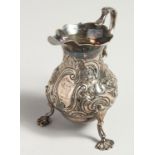 A GEORGE II CREAM JUG with repousse decoration. London 1751