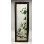A CHINESE FRAMED UPRIGHT PORCELAIN PLAQUE. 29ins high, 8ins wide.