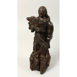 A 17TH CENTURY CARVED WALNUT FIGURE OF A SAINT, possibly Italian. 14ins high.