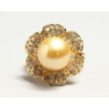 A SILVER GILT PEARL AND CZ RING.