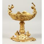 A GOOD GILT BRONZE COMPORT with cherubs. 9.5ins high.