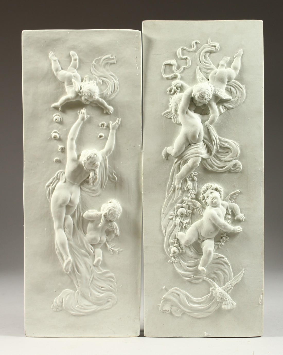 A PAIR OF CLASSICAL PLAQUES 18ins x7ins.