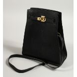 A BLACK LEATHER BAG with long leather handle. 20cm long x 25cm high.
