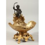 A GOOD GILT BRONZE SALT with a bronze cupid. 7ins high.