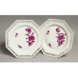 A PAIR OF BERLIN PORCELAIN OCTAGONAL PLATES with pierced borders with flowers in puce. Sceptre