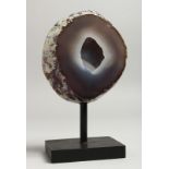 A GEODE 4.5ins, on a wooden base.