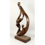 A LARGE ABSTRACT BRONZE, ENTWINED FIGURES on a rectangular base. 34ins high.