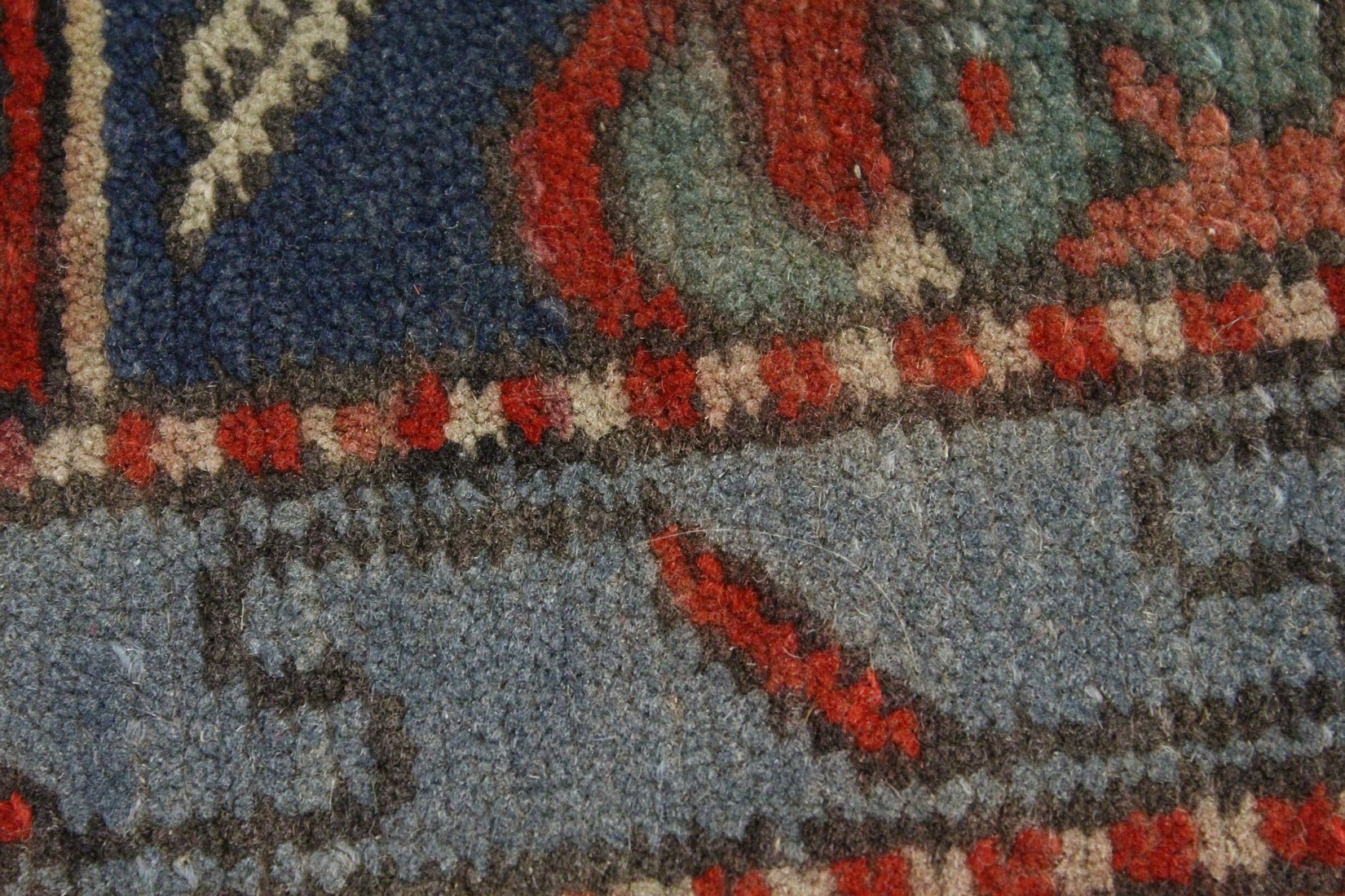 A SMALL PERSIAN RUG, red ground with geometric decoration. 4ft 2ins x 2ft 7ins - Image 2 of 4