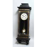 A LATE VICTORIAN EBONISED VIENNA WALL CLOCK, with eight-day movement striking on a gong, white