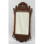 A GEORGE III DESIGN MAHOGANY AND INLAID FRET WORK FRAMED MIRROR with pierced and carved cresting.