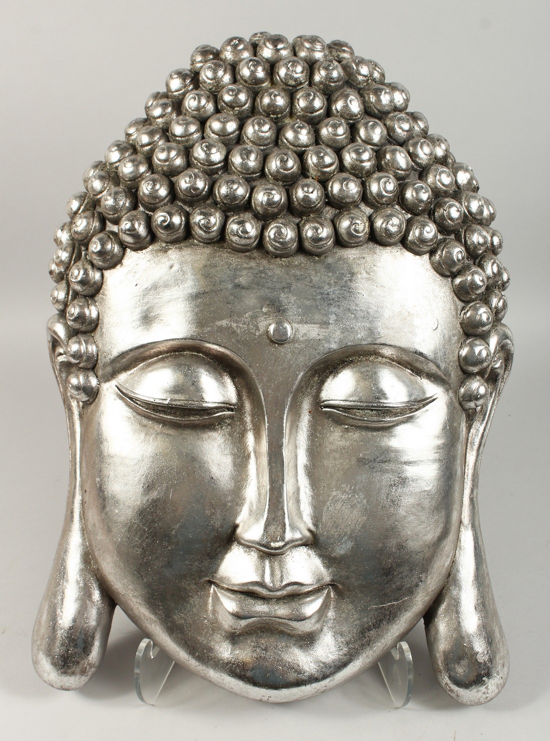 A LARGE SILVERED WALL PLAQUE OF BUDDHA. 20ins long.