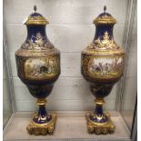 A SUPERB LARGE PAIR OF 19TH CENTURY SEVRES PORCELAIN URNS AND COVERS, rich blue ground with gilt