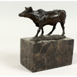 A SMALL BRONZE BULL on a marble plinth. Signed, 5ins high.