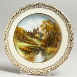 A ROYAL CROWN DERBY PLATE painted with a view of Hadden Hall, by D. Hague, signed, date mark for