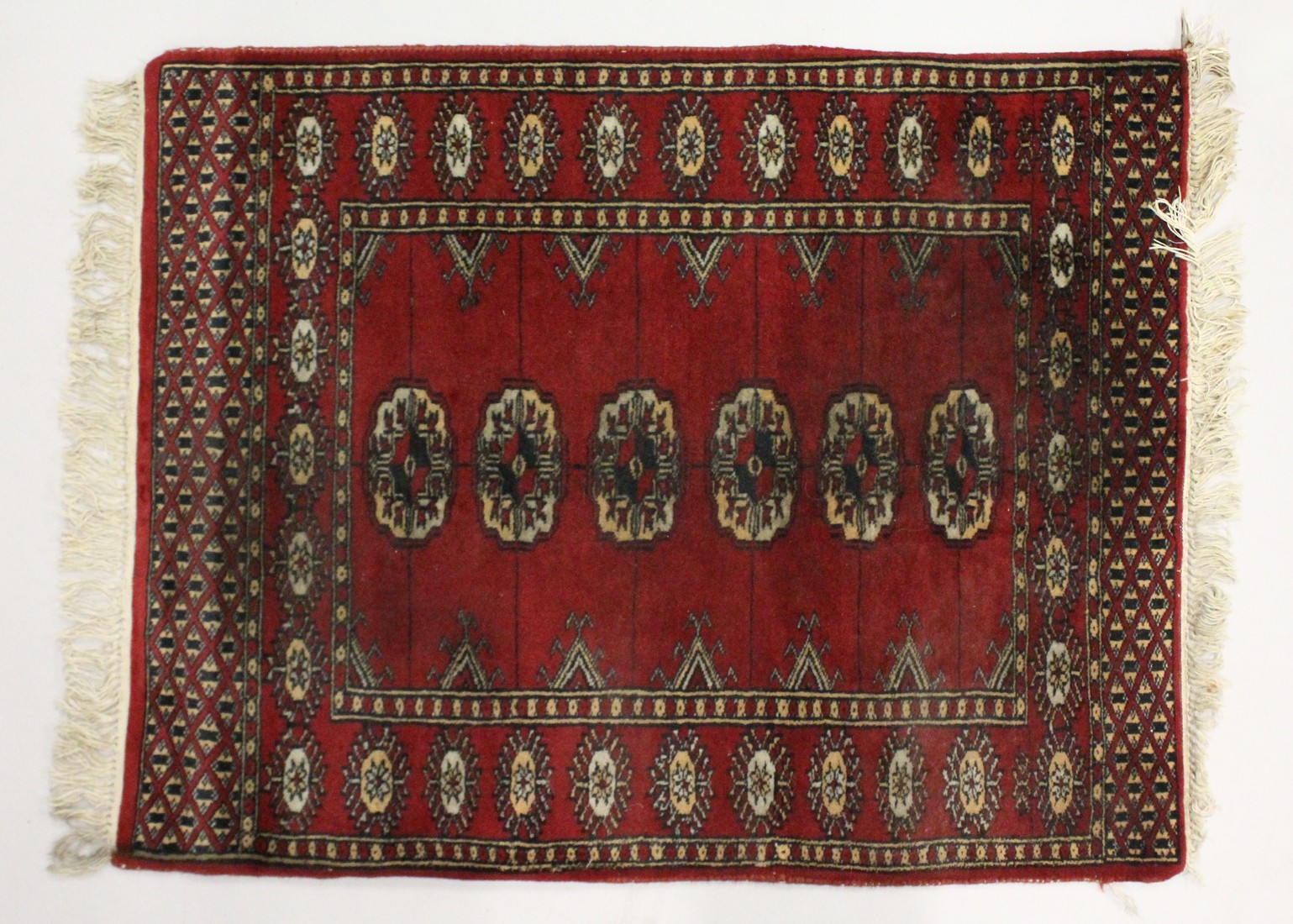 A SMALL BOKHARA RUG, with a single row of five medallions. 2ft 8ins x 2ft 1ins.