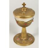 A GOOD EUROPEAN BRASS COMMUNION CHALICE AND COVER set with beads, the lid with a cross. 7.5ins
