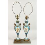 A PAIR OF SEVRES DESIGN PORCELAIN TWO HANDLED VASES converted to lamps. 19ins high.