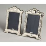 A LARGE PAIR OF SILVER PHOTOGRAPH FRAMES. 19cm x 14cm.