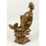 A LARGE CHINESE BRONZE CARP juggling a ball. 16ins high.