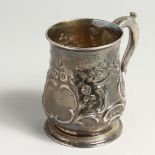 A GEORGE II PINT MUG with repousse decoration. London 1734 weighs 12ozs.