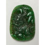 A CHINESE CARVED JADE DRAGON PENDANT, 6cm.