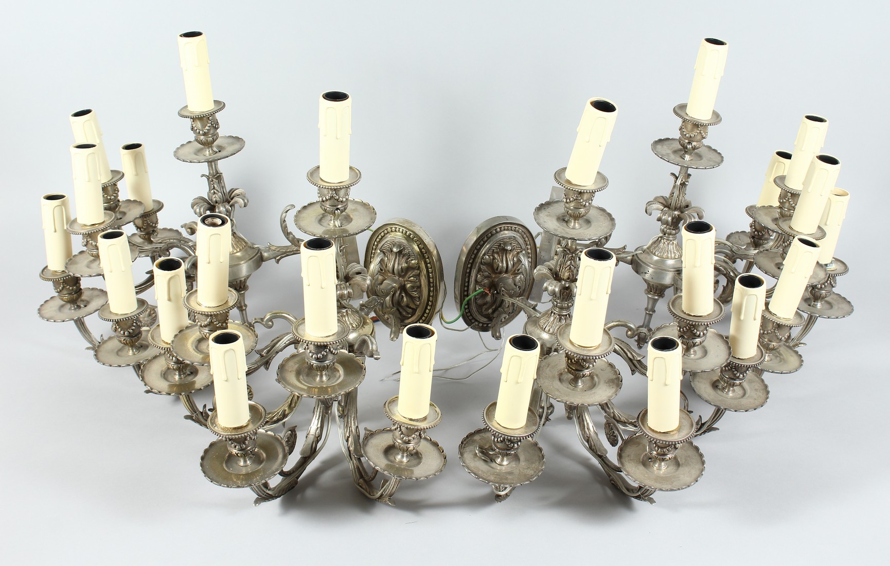 A GOOD SET OF FOUR SILVERED BRASS ADAM REVIVAL SIX LIGHT WALL APPLIQUES with a single light above