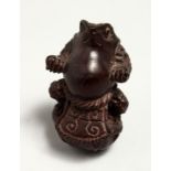 A JAPANESE CARVED WOOD FROG NETSUKE 5cm Signed.