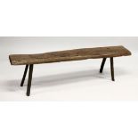 AN EARLY RUSTIC OAK BENCH SEAT on four legs. 5ft 2ins long x 1ft 4ins high.