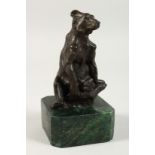 A SMALL BRONZE OF A SEATED BEAR on a marble base. 5ins high.