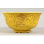 A CHINESE YELLOW GROUND BOWL decorated with dragons. 6ins diameter.