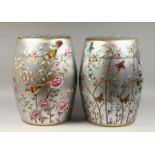 A PAIR OF CHINESE SILVER POTTERY BARREL SEATS painted with birds and flowers. 17ins high.