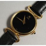 A LADIES 18CT GOLD EBEL WRISTWATCH with leather strap in an original leather pouch.