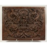 A GOOD OAK PANEL 18TH CENTURY carved with urn, birds, wolf, and coat. 18ins x 23ins.