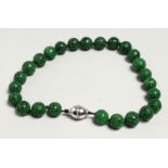A GOOD CARVED JADE NECKLACE with 18ct white gold and diamond clasp