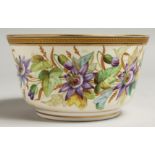 A ROYAL WORCESTER BOWL painted with a gilt and black border painted with passion flowers.