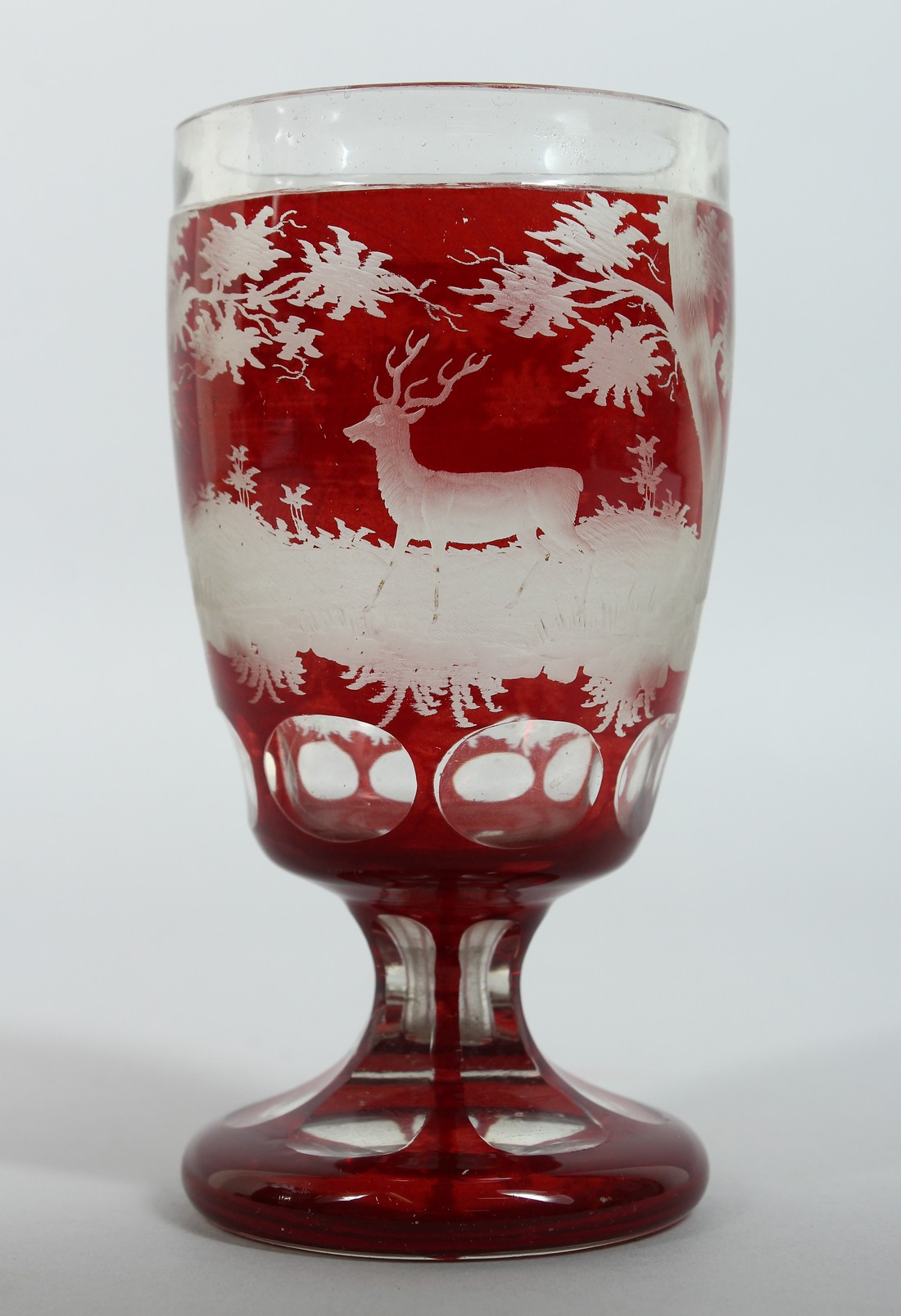 A GOOD BOHEMIAN GOBLET engraved with deer in a landscape on a circular base. 5.5ins high.