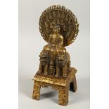 A GILT BRONZE FIGURE sitting on a horse, with two lions. 11ins high