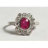 AN 18CT WHITE GOLD RUBY AND DIAMOND CLUSTER RING.