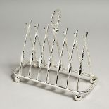 A SILVER-PLATED SIX DIVISION TOAST RACK with cross rifles.