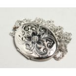 A SILVER OVAL LOCKET AND CHAIN.