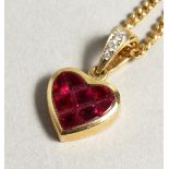 AN 18CT GOLD RUBY SET HEART PENDANT AND CHAIN.