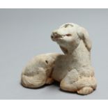 A SMALL CARVED STONE ANTIQUITY DOG. 3.5ins.