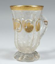 A GOOD CLEAR GLASS BOHEMIAN TANKARD with four gilt oval panels of buildings 4.5ins high.