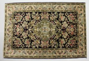 A PERSIAN DESIGN PART SILK RUG, black ground with all over floral decoration. 5ft x 3ft 6ins.