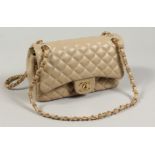 A GOOD PADDED BEIGE BAG with leather and chrome handles. 24ins long No. 59812096.