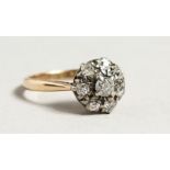 AN 18CT GOLD DIAMOND CLUSTER RING