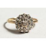 A 9CT GOLD DIAMOND CLUSTER RING.