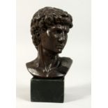 A GRAND TOUR BRONZE BUST on a marble plinth. 5ins high.